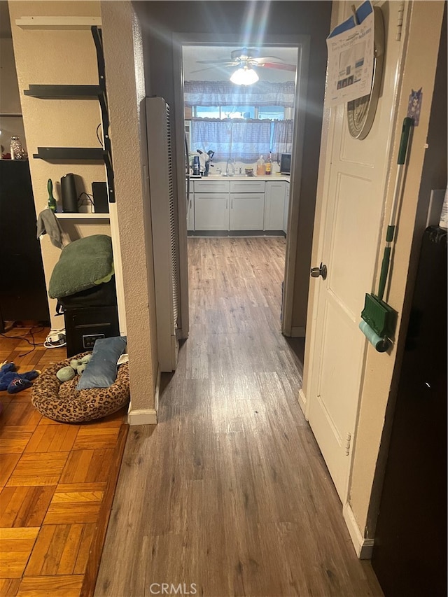 hall with dark wood-type flooring and sink