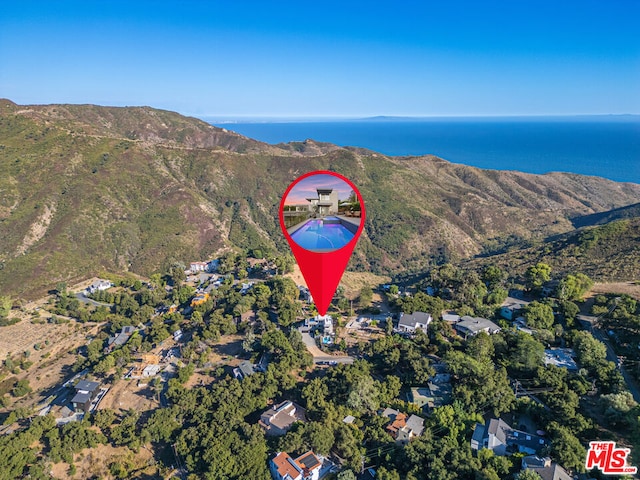 drone / aerial view with a water and mountain view