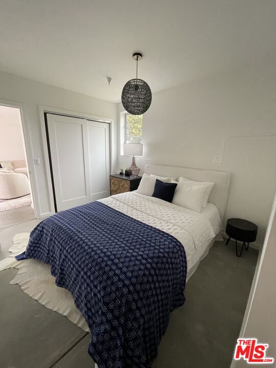 carpeted bedroom featuring a closet