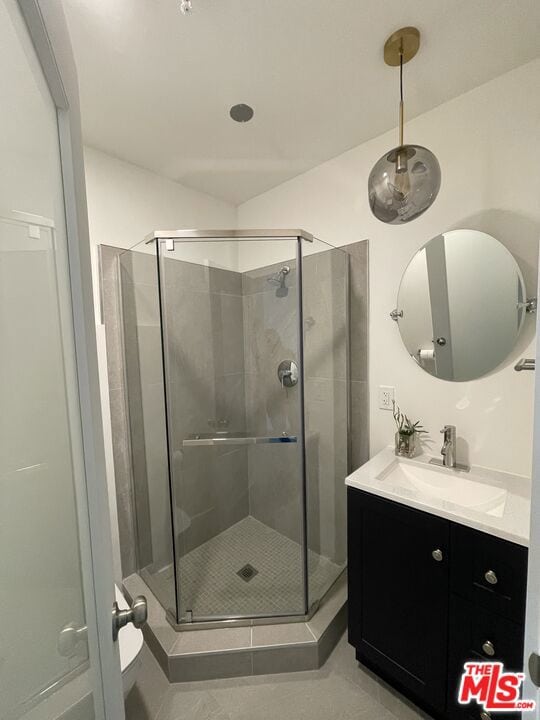 bathroom with vanity, tile patterned flooring, and an enclosed shower