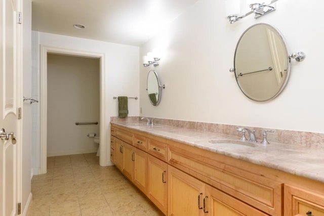 bathroom with toilet and vanity