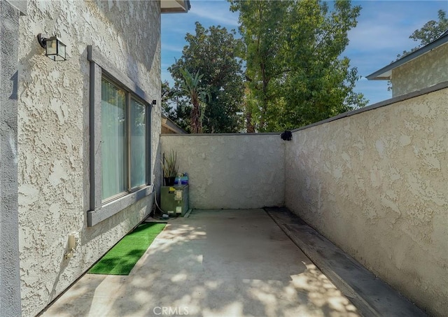 view of side of home with a patio