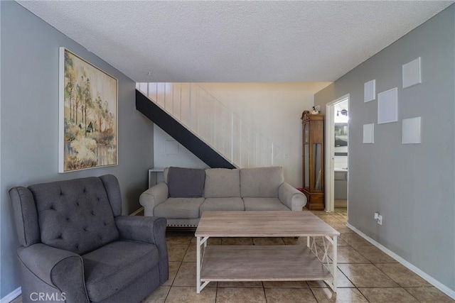 living room featuring light tile patterned floors and a textured ceiling