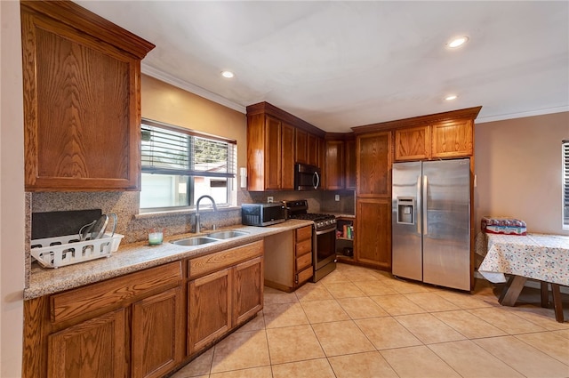 kitchen featuring sink, light tile patterned floors, ornamental molding, appliances with stainless steel finishes, and decorative backsplash