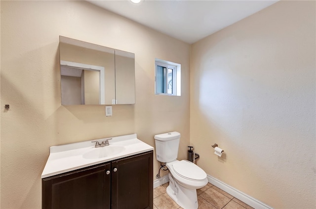 bathroom featuring tile patterned flooring, vanity, and toilet