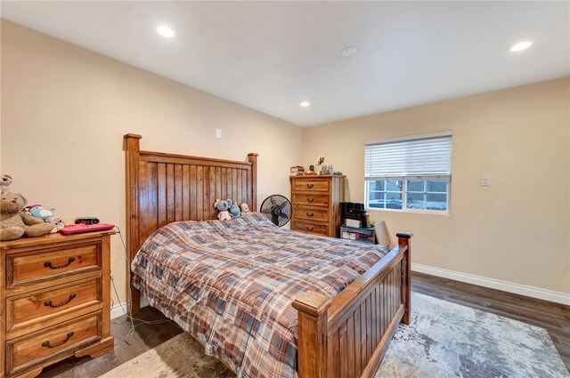 bedroom with dark wood-type flooring