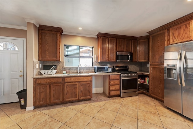 kitchen featuring light tile patterned flooring, stainless steel appliances, crown molding, and sink