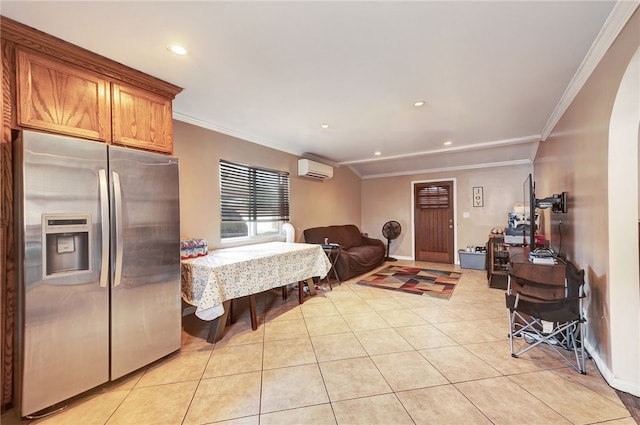 kitchen with stainless steel refrigerator with ice dispenser, an AC wall unit, light tile patterned floors, and crown molding