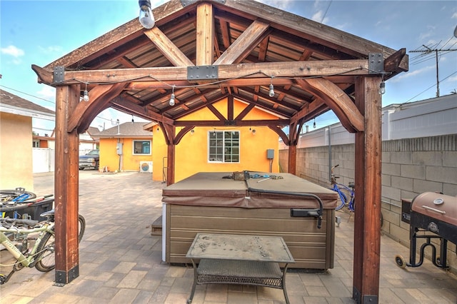 view of patio featuring a gazebo, a grill, and a hot tub