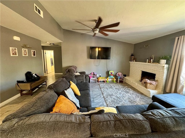 living room with ceiling fan, lofted ceiling, and a brick fireplace