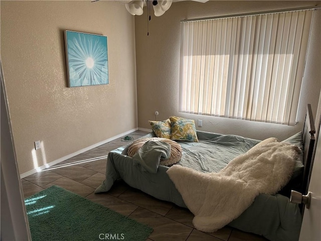 bedroom featuring tile patterned floors and ceiling fan