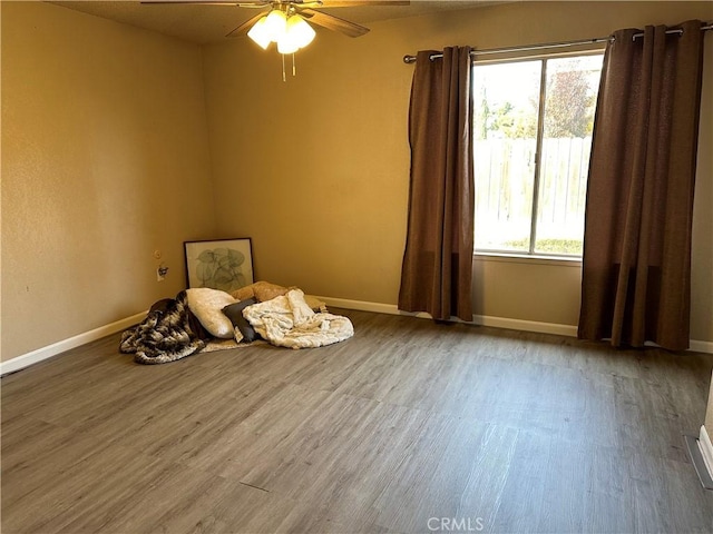 interior space with hardwood / wood-style floors and ceiling fan