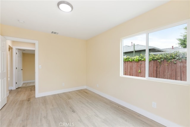 spare room featuring light hardwood / wood-style floors