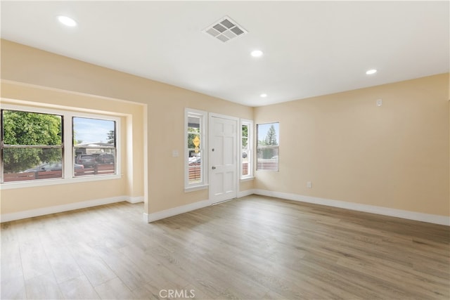 interior space with light hardwood / wood-style floors and a healthy amount of sunlight