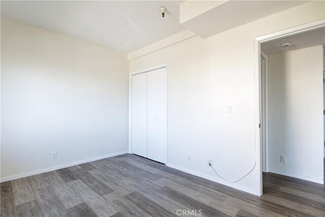 spare room featuring dark wood-type flooring