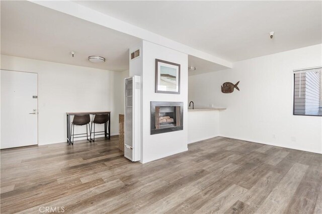 unfurnished living room featuring wood-type flooring