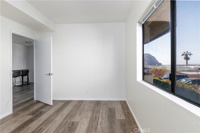 empty room with dark hardwood / wood-style floors