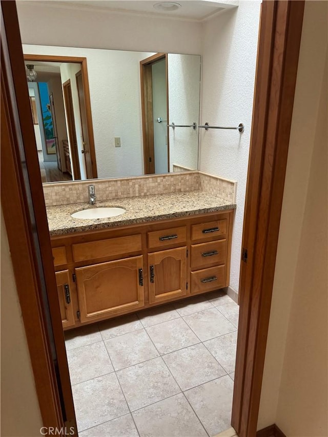 bathroom featuring tile patterned flooring and vanity