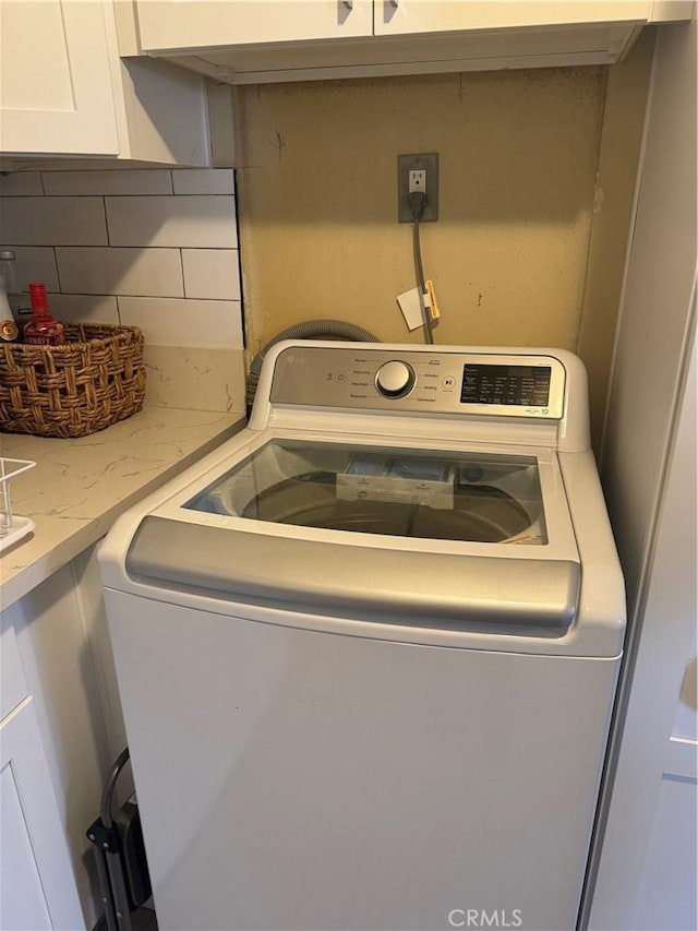 clothes washing area featuring washer / dryer