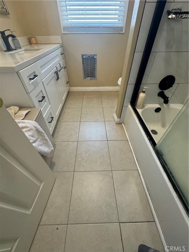 full bathroom with toilet, tile patterned flooring, vanity, and combined bath / shower with glass door