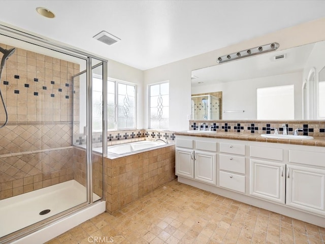 bathroom with vanity and independent shower and bath