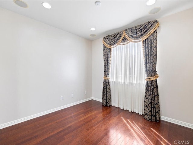 spare room with dark wood-type flooring