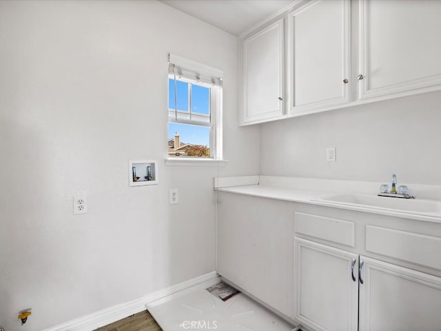 clothes washing area featuring washer hookup, cabinets, and sink