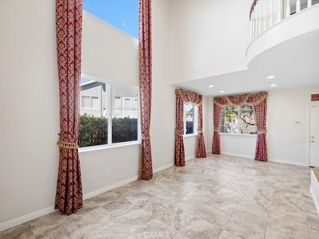 unfurnished living room with a high ceiling