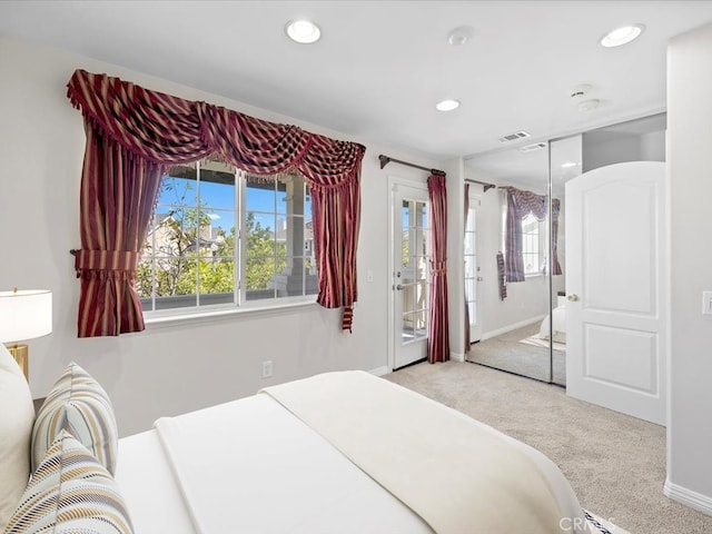 bedroom featuring light carpet and a closet