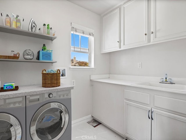 laundry area featuring cabinets, sink, washer and dryer, and light tile patterned flooring