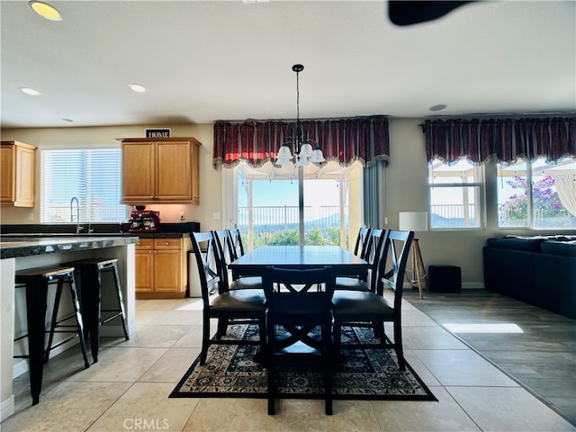 dining room with an inviting chandelier and light tile patterned flooring