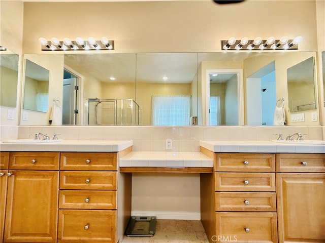 bathroom with vanity, a shower with shower door, backsplash, and tile patterned flooring