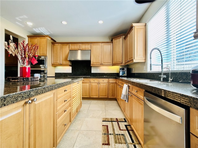 kitchen with decorative backsplash, sink, light tile patterned floors, and stainless steel appliances