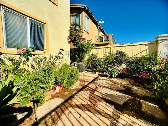 exterior space with central air condition unit and a patio area