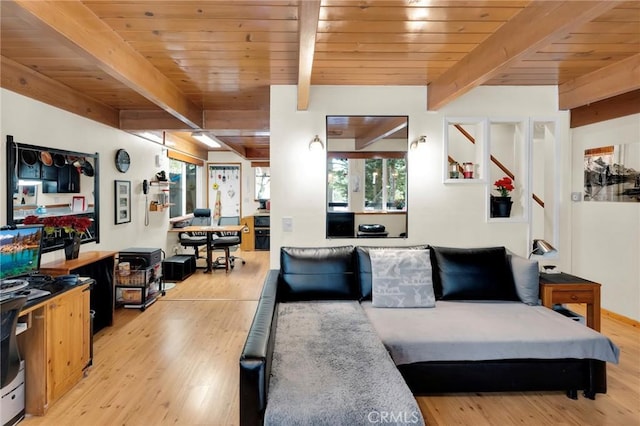 living room featuring stairs, light wood finished floors, beam ceiling, and wood ceiling