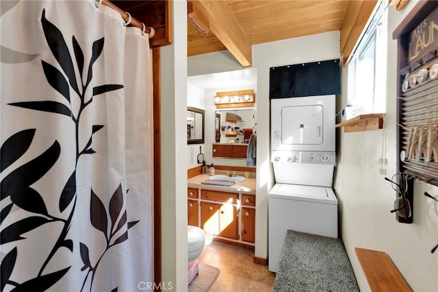 clothes washing area featuring laundry area, stacked washing maching and dryer, and wood ceiling