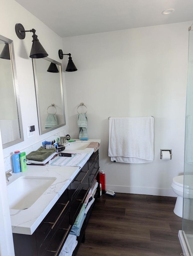 bathroom featuring hardwood / wood-style floors, vanity, and toilet