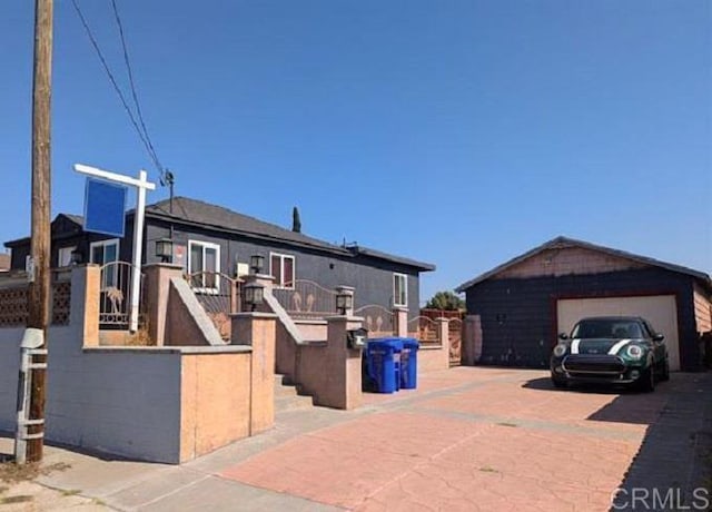 view of front of home featuring an outbuilding and a garage