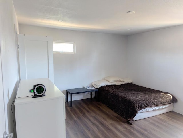 bedroom with dark wood-type flooring