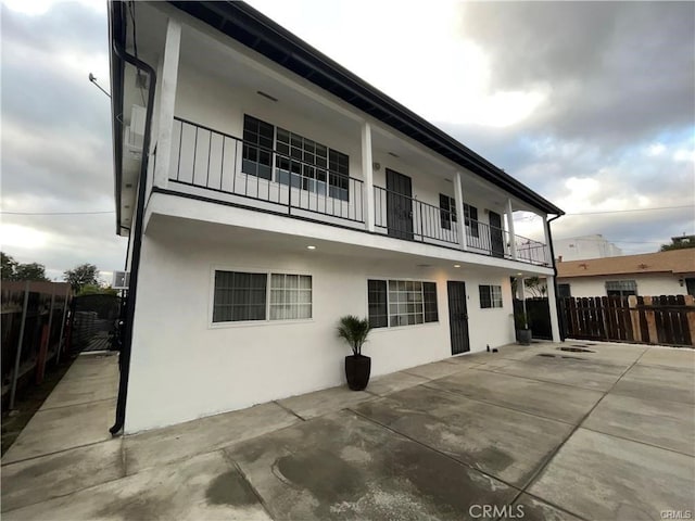 exterior space featuring a balcony and a patio area