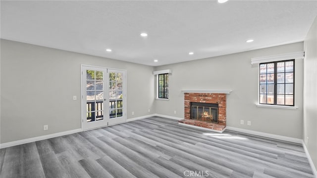 unfurnished living room featuring light hardwood / wood-style floors and plenty of natural light