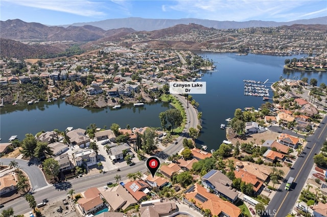 birds eye view of property with a water and mountain view