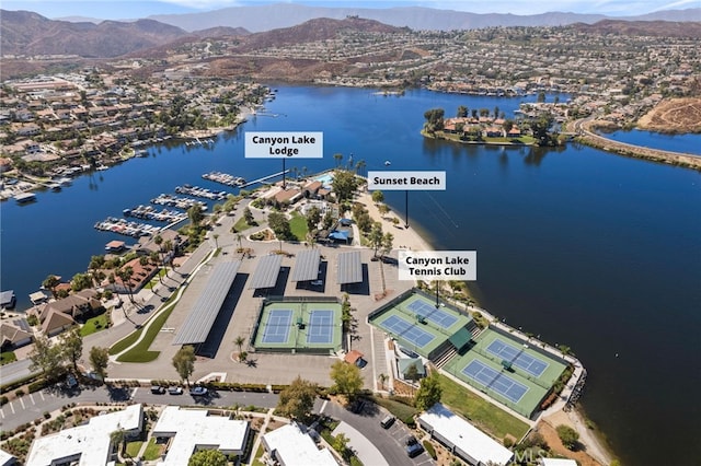 drone / aerial view featuring a water and mountain view