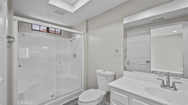 bathroom featuring vanity, toilet, and walk in shower