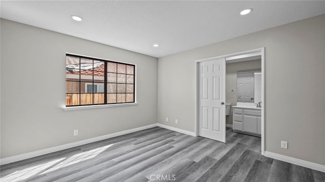 unfurnished bedroom featuring dark hardwood / wood-style floors and a closet