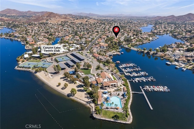 birds eye view of property with a water and mountain view