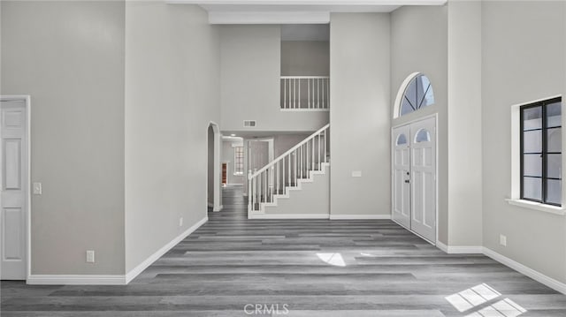 entryway featuring a high ceiling and hardwood / wood-style flooring