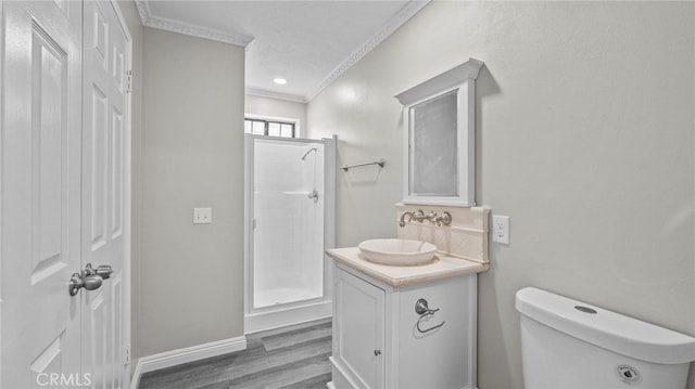 bathroom with walk in shower, ornamental molding, vanity, wood-type flooring, and toilet