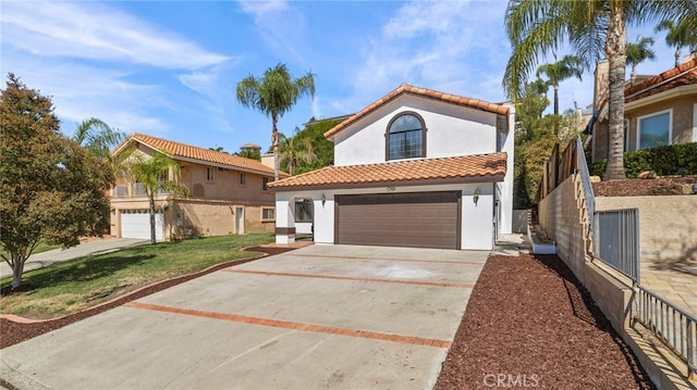 mediterranean / spanish-style house with a garage