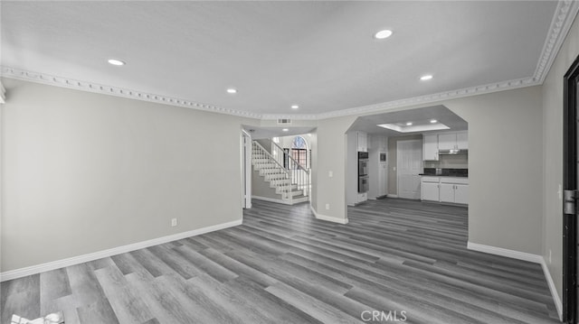 unfurnished living room with crown molding and hardwood / wood-style flooring